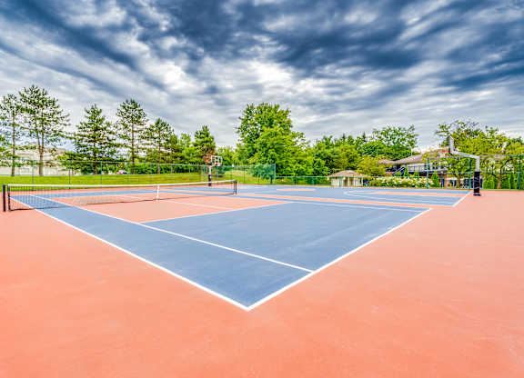 A tennis court with a blue line in the middle of it.