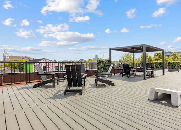 A wooden deck with chairs and a table.