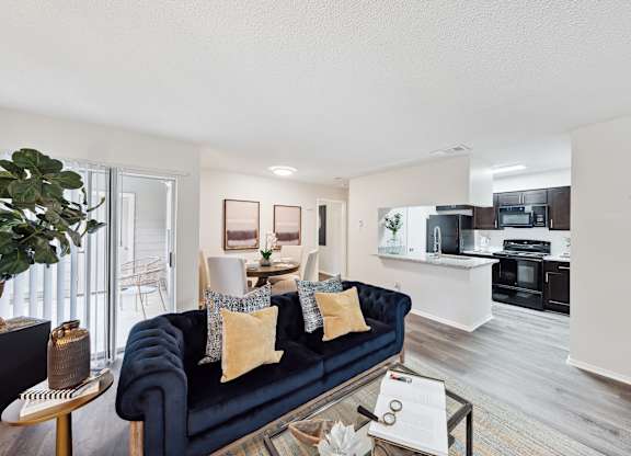 A living room with a blue couch and a coffee table.