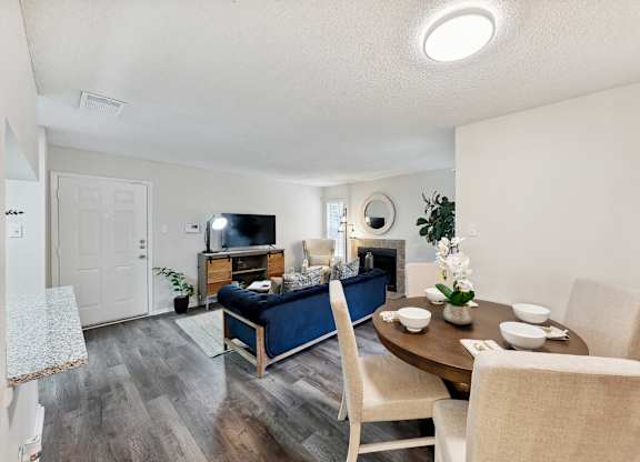 A living room with a blue couch and a wooden table.