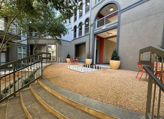 Courtyard with a chess board and chairs at Civic at Frisco Square Apartments, Frisco, TX, Texas
