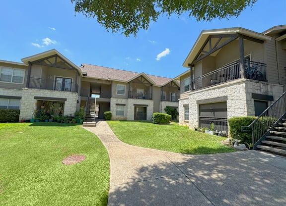 A sunny day at a residential complex with a clear blue sky.