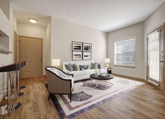 A living room with a couch, coffee table, and pictures on the wall.