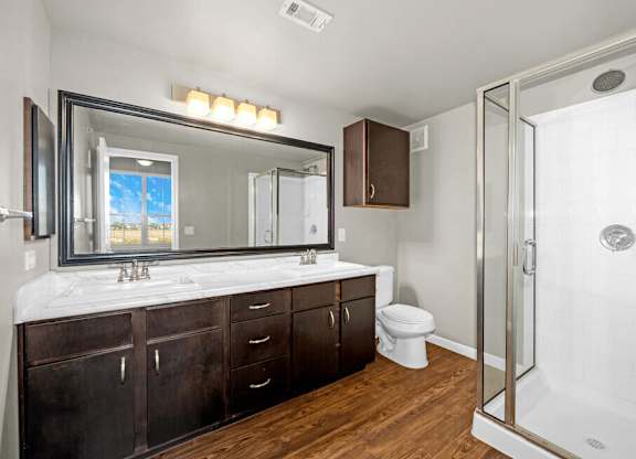A bathroom with a white tub and a large mirror.