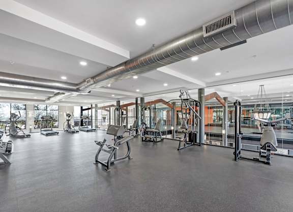 A gym with a variety of exercise equipment.