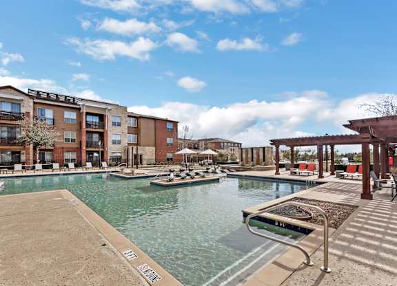 A pool area with boats and a building in the background.
