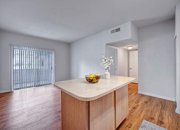 A kitchen island with a bowl of fruit on it.