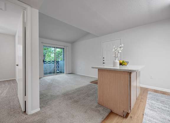 A room with a carpeted floor and a wooden cabinet.