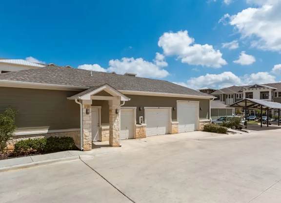 A house with a brown roof and a white garage door.