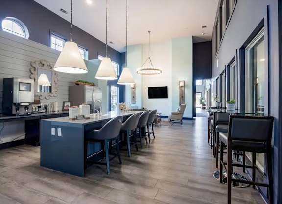 A modern kitchen with a dining area and a bar.
