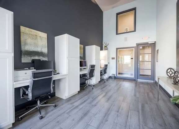 A room with a grey floor and white furniture.