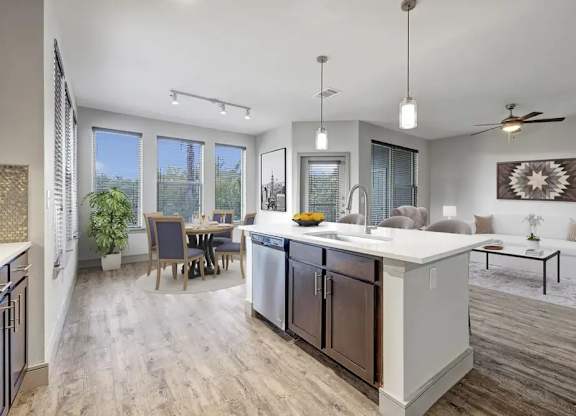 A modern kitchen with a dining table and chairs.