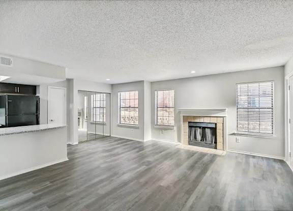 A spacious living room with a fireplace and sliding glass doors.