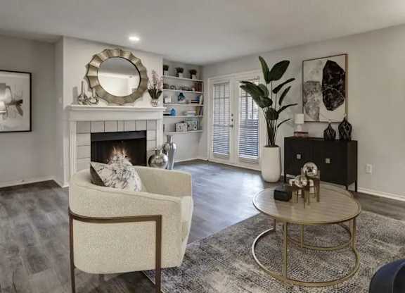 A living room with a fireplace and a chair.