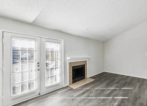 A room with a fireplace and a sliding door.