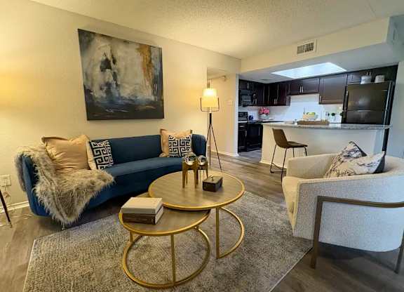 A living room with a blue couch and a coffee table.