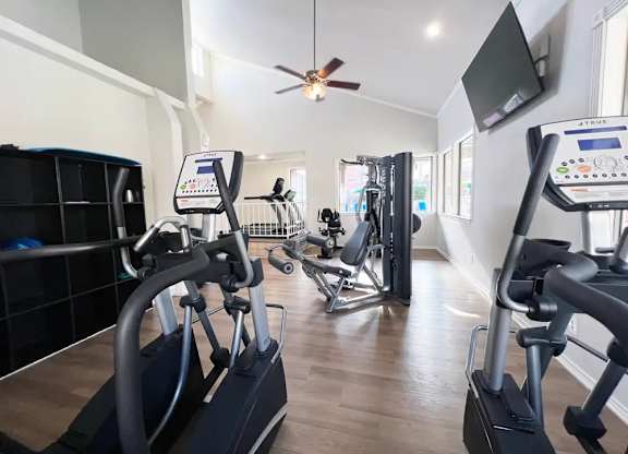 A gym with treadmills and elliptical machines.