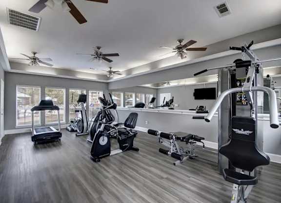 A spacious home gym with a variety of exercise equipment.