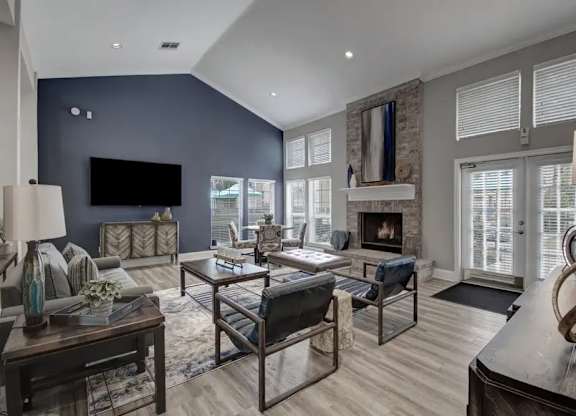 A modern living room with a fireplace and a television.