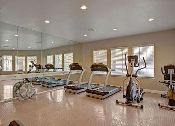 A spacious home gym with a variety of exercise equipment.