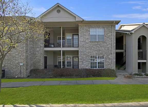 A two-story building with a balcony on the second floor.