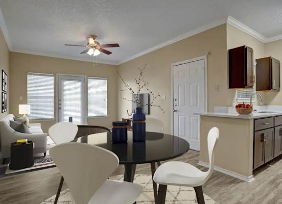 A modern dining room with a black table and white chairs.