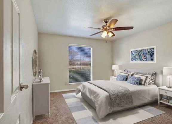 A bedroom with a bed, nightstand, and window.
