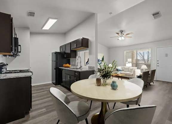 A modern kitchen with a dining table and chairs.