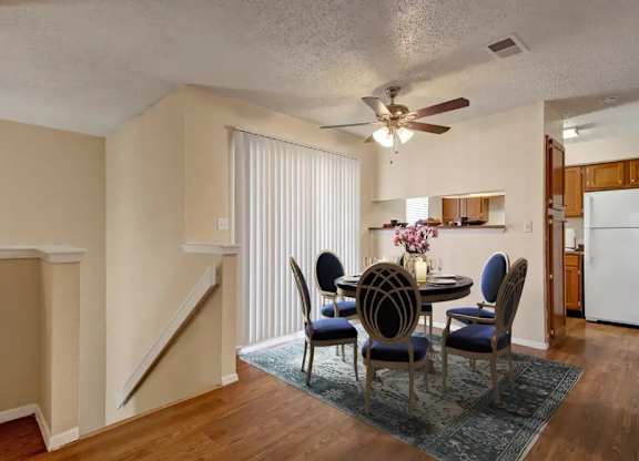 A dining room with a table set for four.