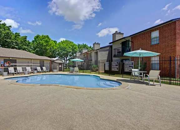 Pool area with spa and lounge seating at South Meadows Apartments, Texas, 75154