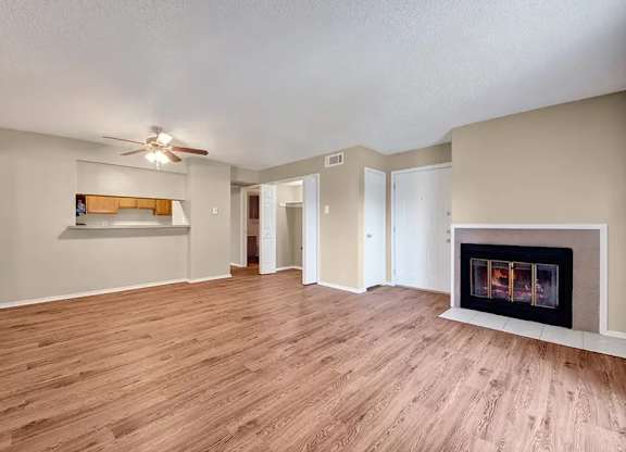 Open living and dining room with fireplace at South Meadows Apartments, Red Oak