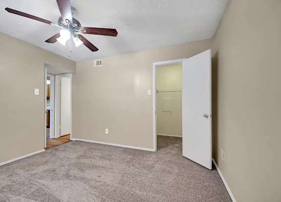 Bedroom with walk-in closet and attached bathroom at South Meadows Apartments, Red Oak, TX 75154