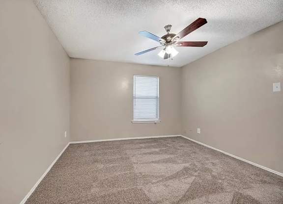 Spacious bedroom with vaulted ceiling and window blinds at South Meadows Apartments, Red Oak, TX