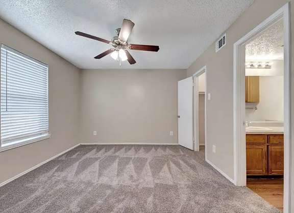 Vacant bedroom with en suite bathroom access at South Meadows Apartments, Red Oak, 75154