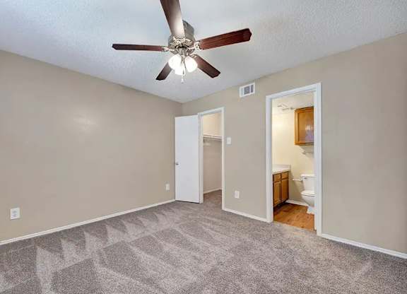 Bedroom with walk-in closet and private bathroom at South Meadows Apartments, Red Oak, Texas