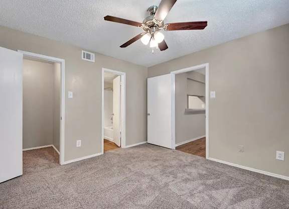 Bedroom with multiple closets and bathroom access at South Meadows Apartments, Red Oak