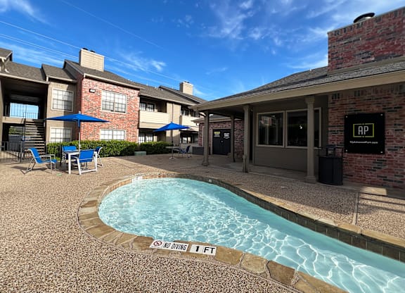 Pool area with covered patio seating at Ashwood Park Apartments, Texas, 75252