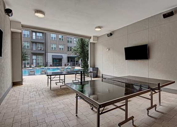 Poolside Outdoor Yard Game Area at Civic at Frisco Square Apartments, Frisco