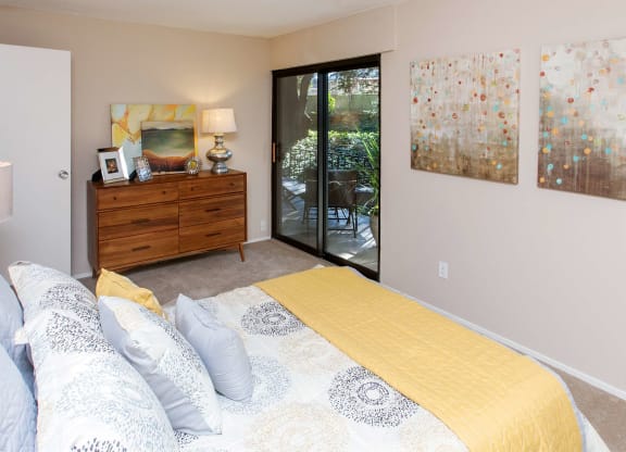a bedroom with a bed and a dresser