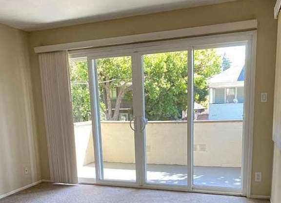 an empty living room with sliding glass doors