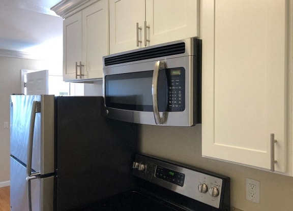 a kitchen with a microwave and a refrigerator