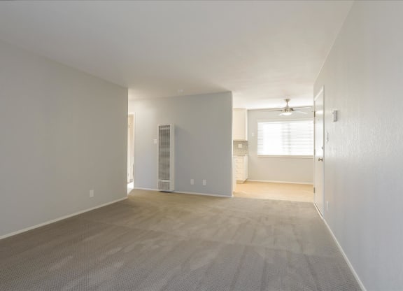 an empty living room with a closet and a bathroom