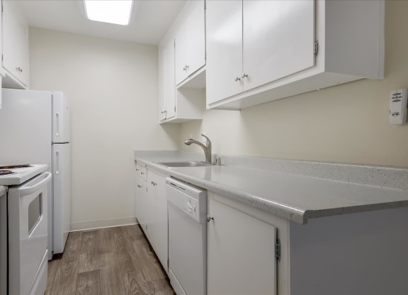 a kitchen with white appliances and white cabinets