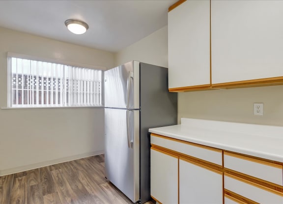 a kitchen with a refrigerator and a window