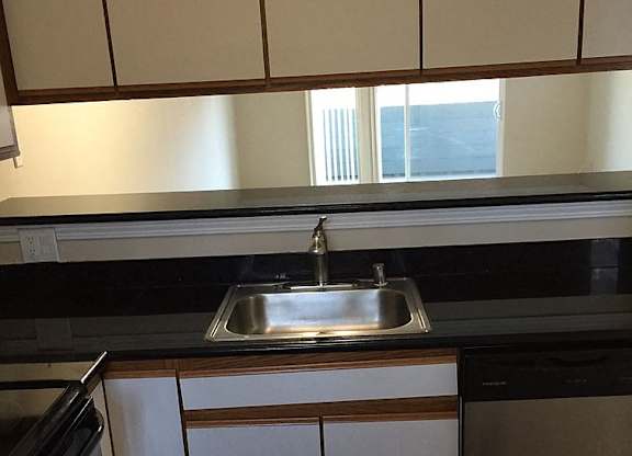 A kitchen with a sink and cabinets.