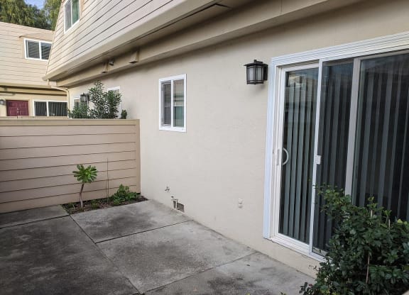 a patio outside of a house with a glass door
