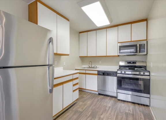 a kitchen with stainless steel appliances and white cabinets