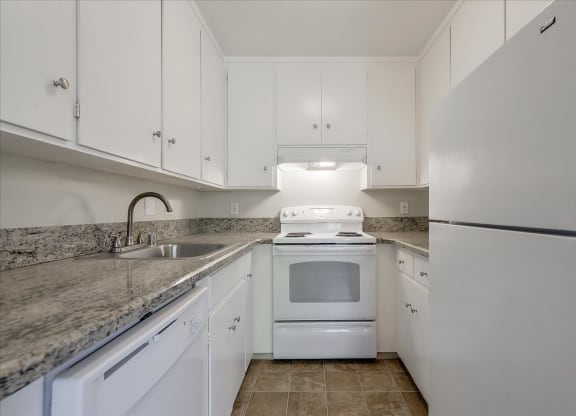 a kitchen with white appliances and white cabinets