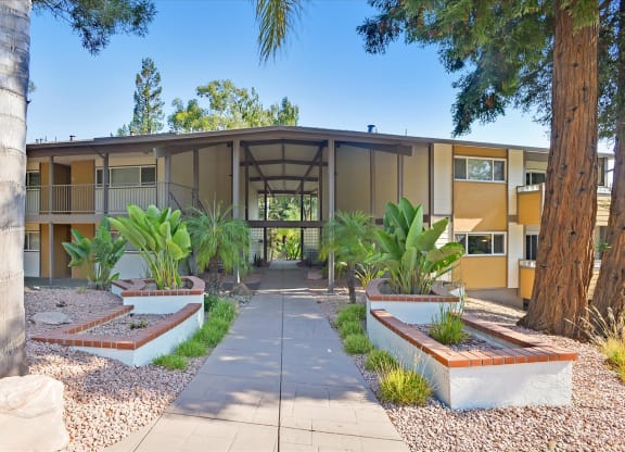 a building with a courtyard with plants and trees