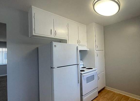 a kitchen with a refrigerator and a stove